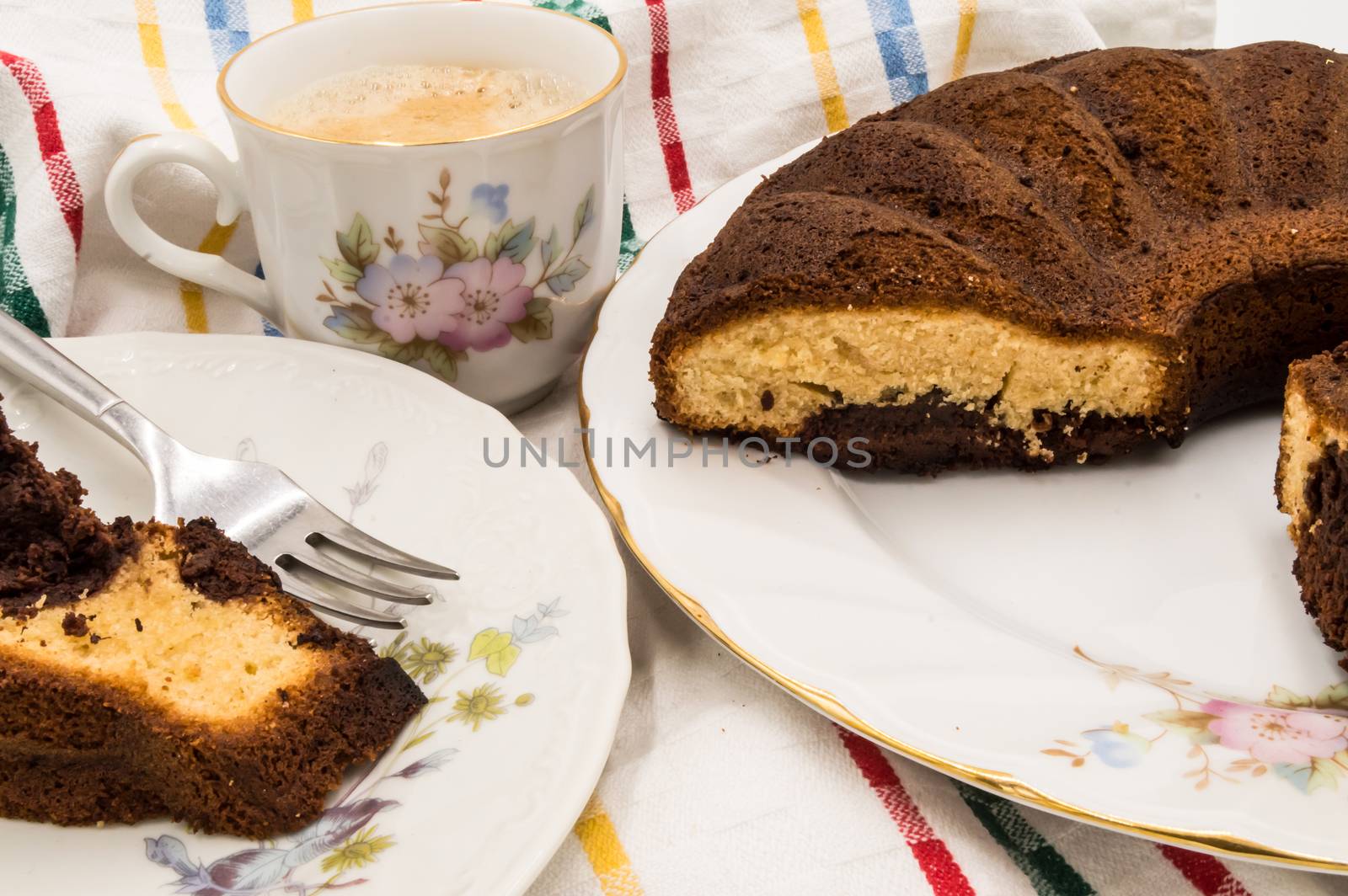 Slice of marbled cake on a plate with a cup of coffee on a coloring background