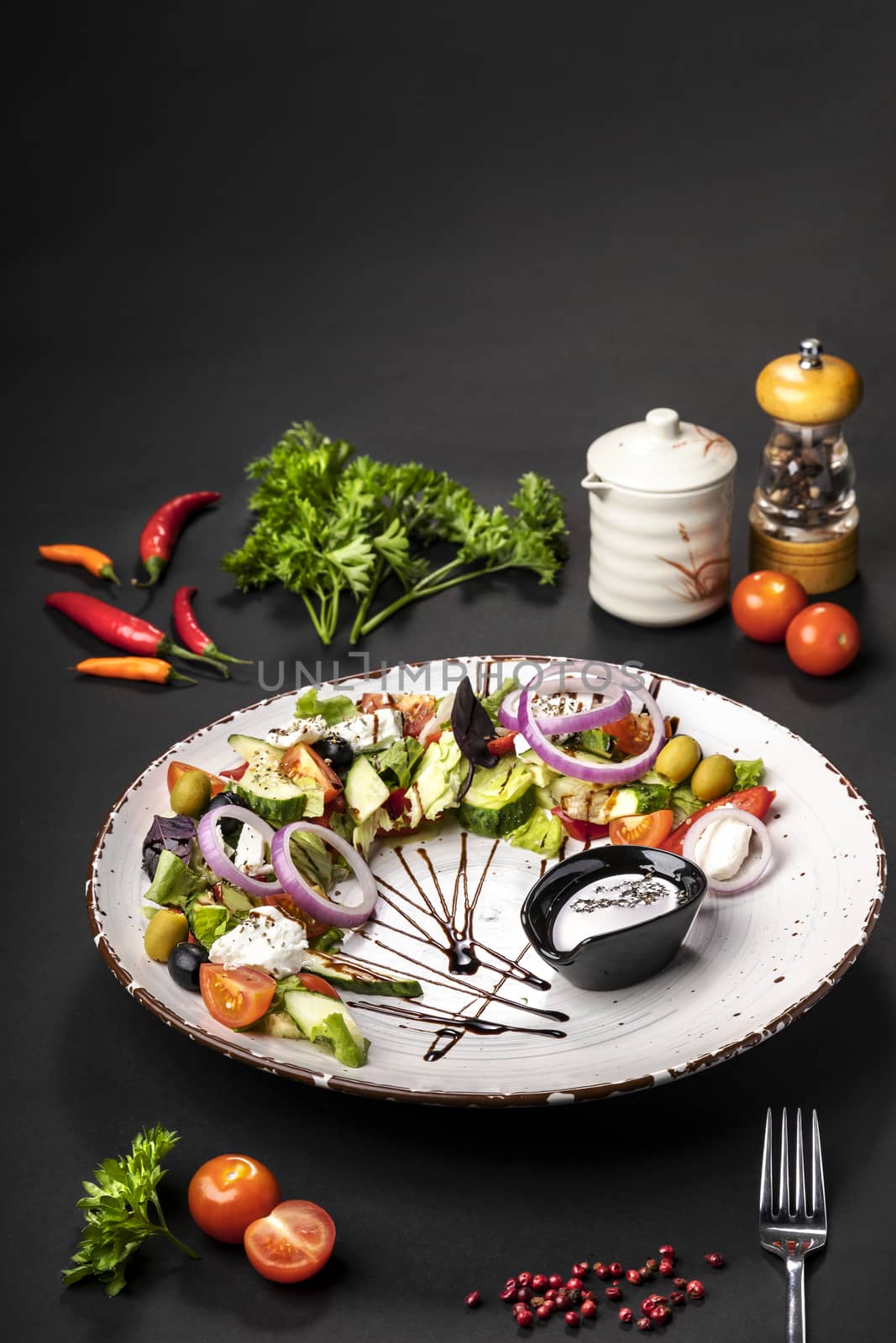 salad on a white dish on a black background by sveter