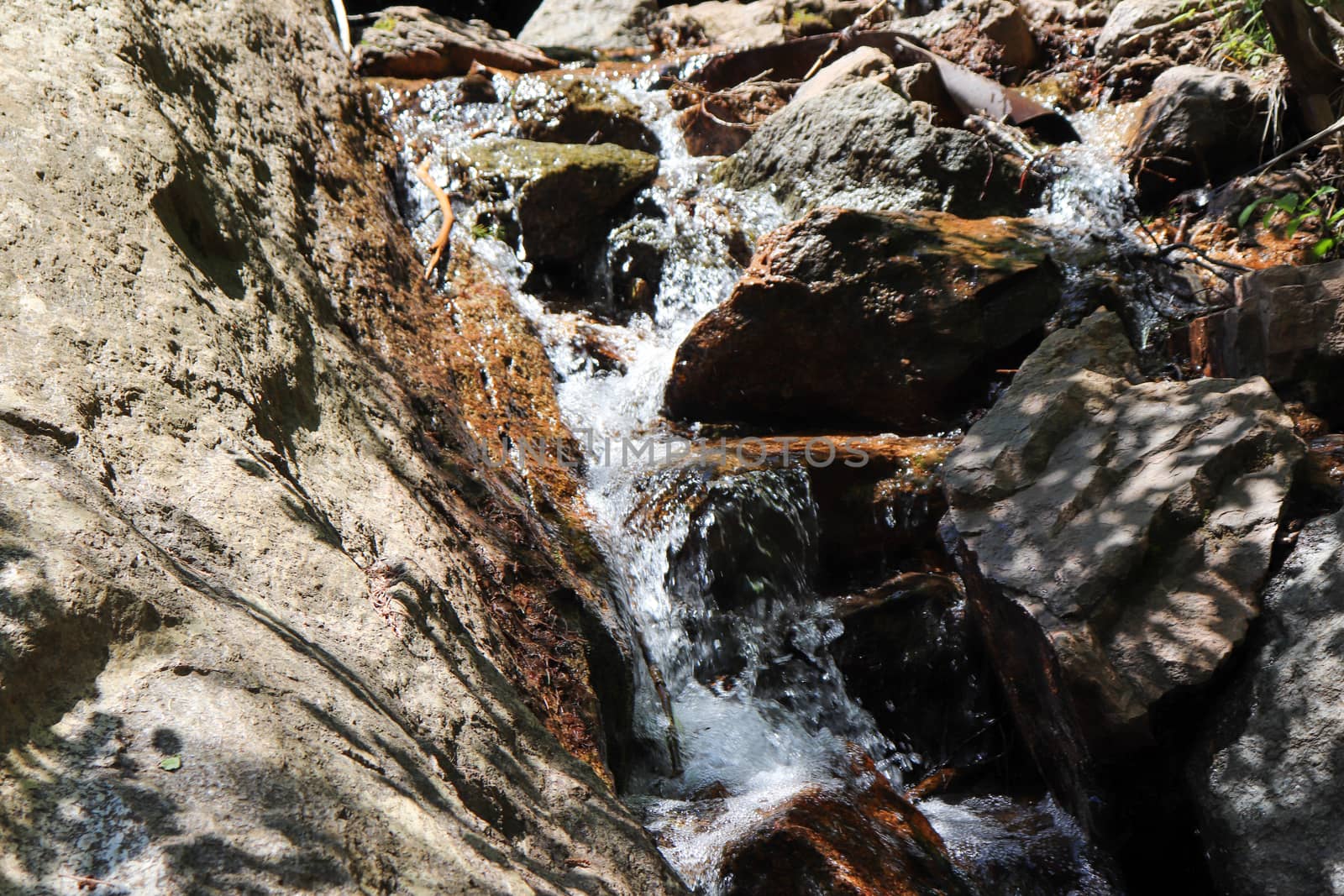 A small waterfall over a rocky cliff