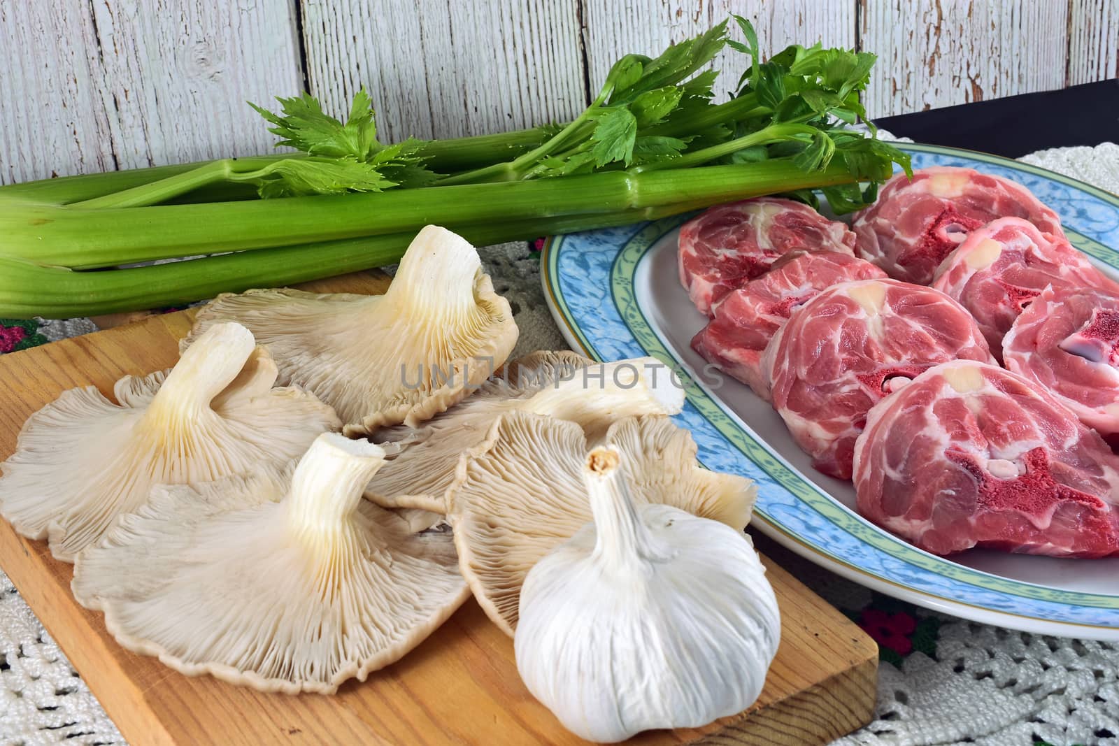 sliced raw lamb neck and mushrooms