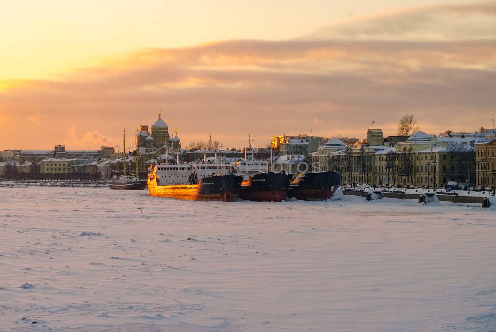 St. Petersburg, Russia - January 26, 2011:  Winter sunset view of the Big Neva and the embankment of Lieutenant Schmidt from the Annunciation (Blagoveshchensky) bridge with ships, St. Petersburg, Russia