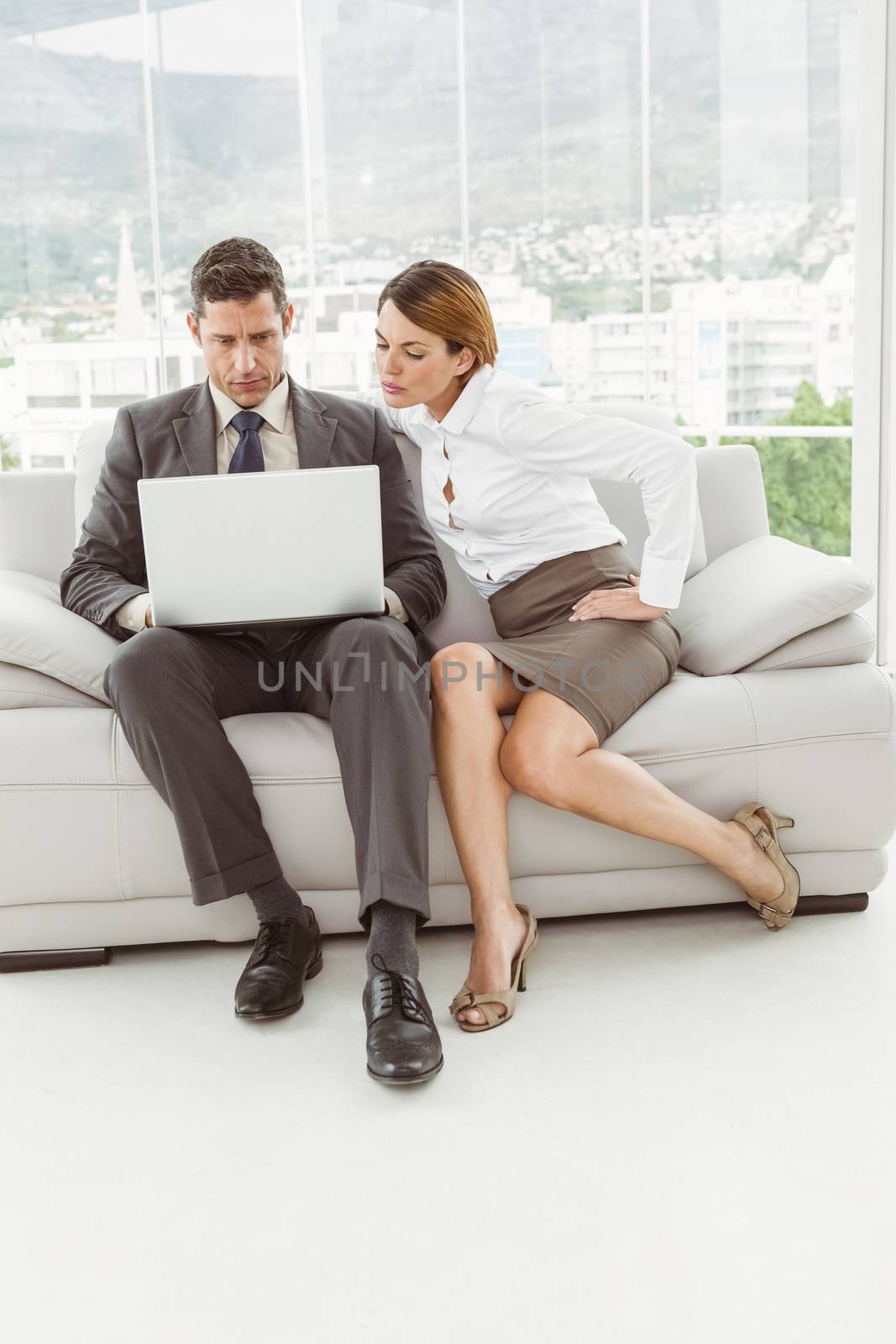 Young business people using laptop in the office