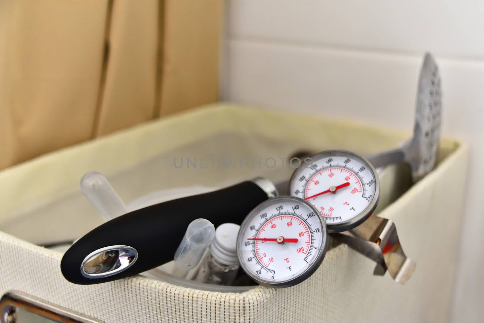 A cheese making kit with thermometers, a pipette and a strainer