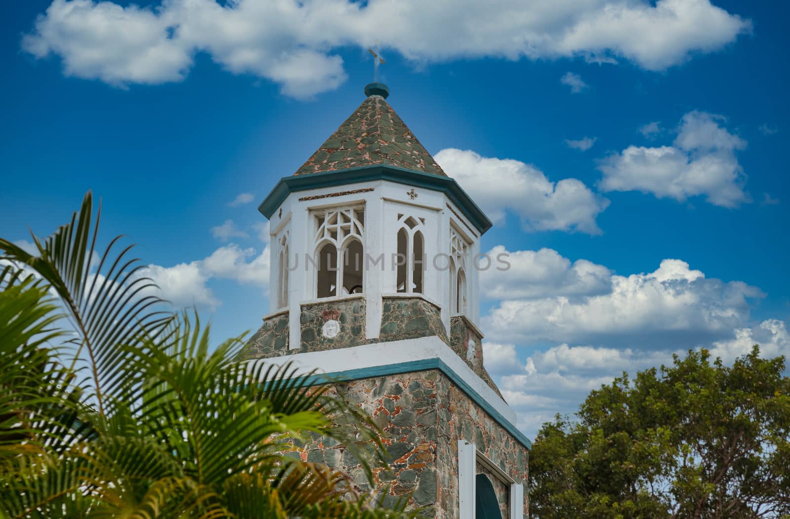 A wood and stone tower on an old church in the tropics