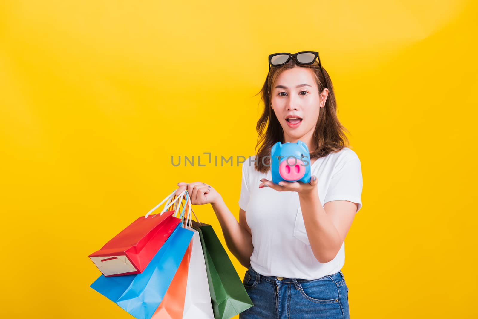 woman happy hold colorful shopping bags and Piggybank Saving mon by Sorapop