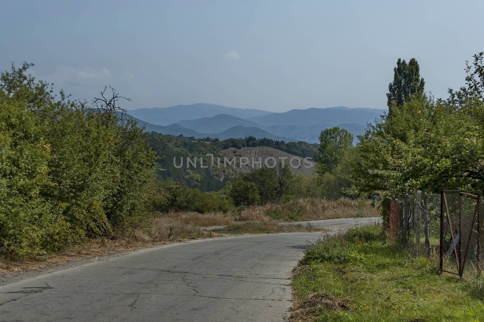 Autumn landscape of  deciduous forest with glade and road in the Sredna Gora, mountain, Bulgaria