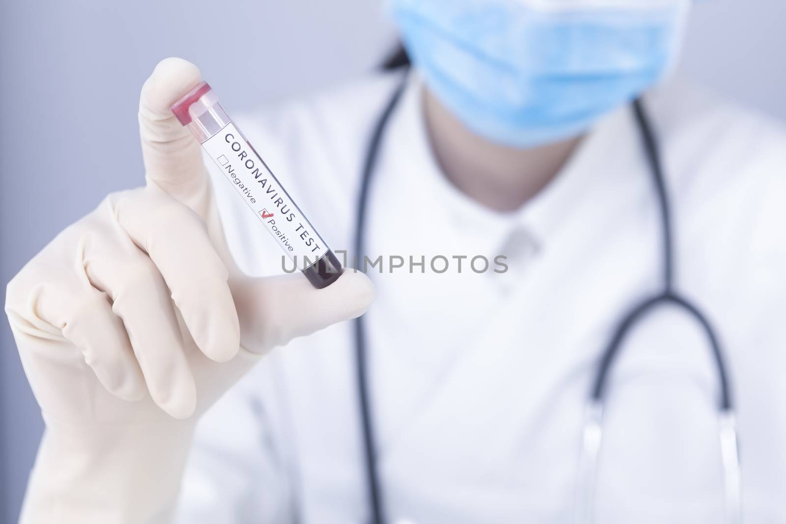 Doctor hand with protective gloves holding COVID 19 Coronavirus test blood. Virus test and research concept. Focus on coronavirus test.