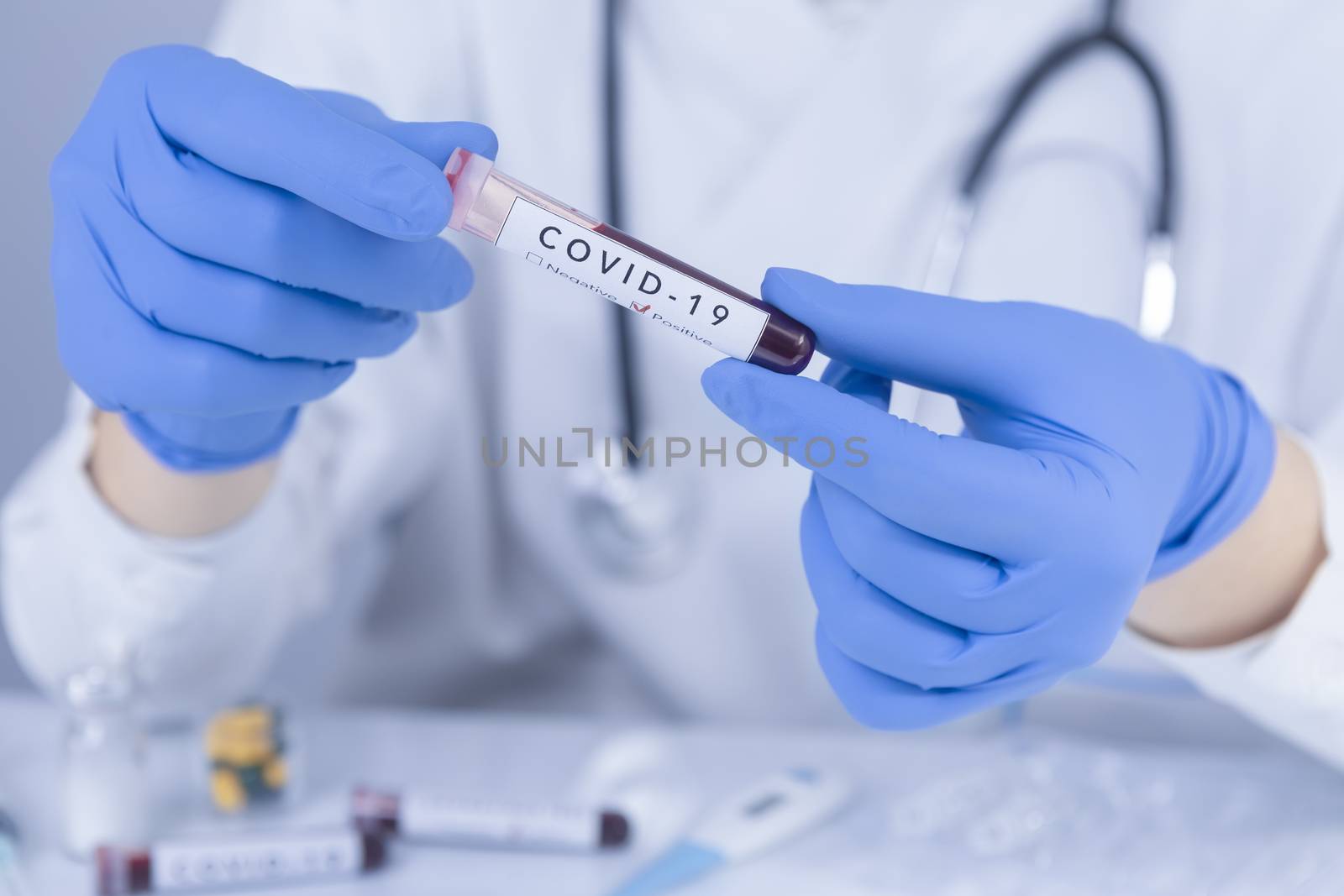 Doctor hands with protective gloves analyzing COVID 19 Coronavirus test blood. Virus test and research concept. Closeup
