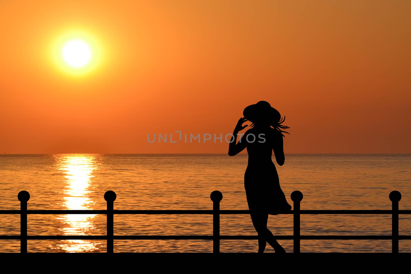 Silhouette of a woman on the waterfront at sunrise by hibrida13
