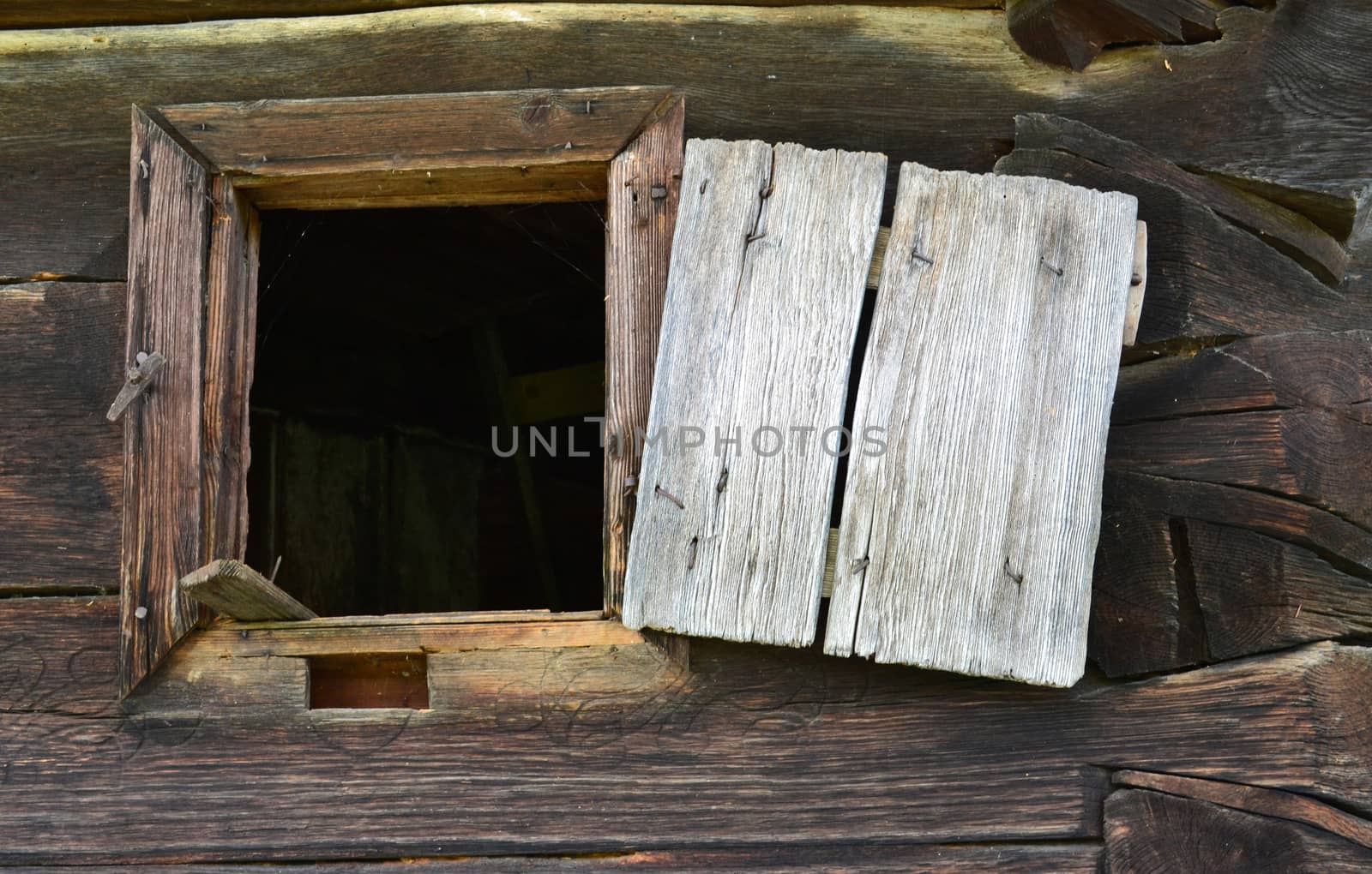 Open window of an old house built of round logs by hibrida13