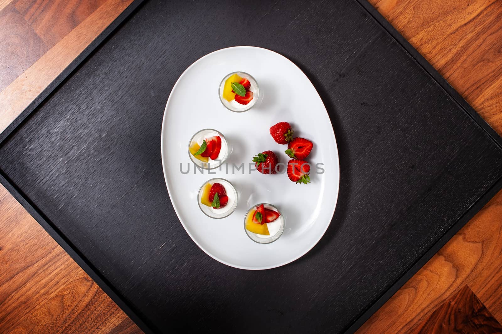 white plate with strawberries and mango. Lifestyle food by PeterHofstetter