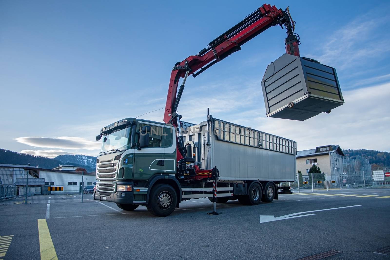 truck with crane emtying recycle. by PeterHofstetter