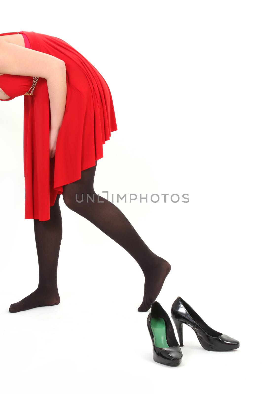 woman with red dress and back shoes on white background