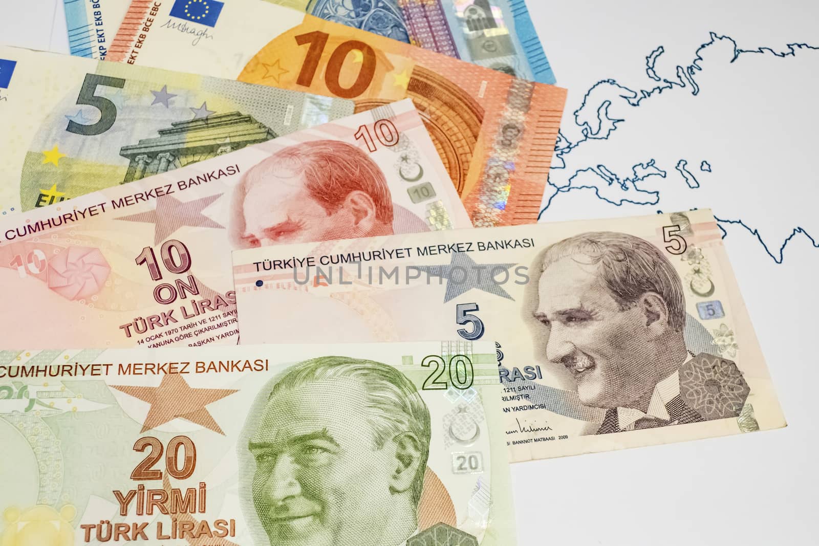 close up turkish lira banknotes with euro bankmotes on background