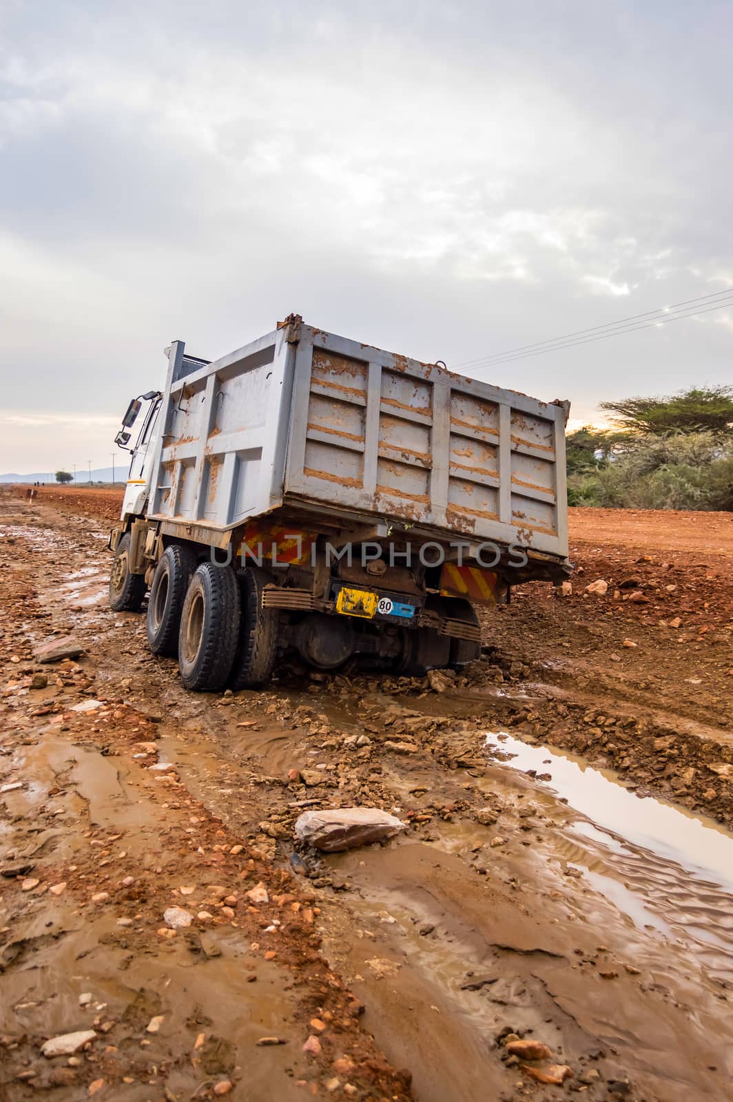 Truck stuck. The rear wheels are muddy. Mud road  by Philou1000