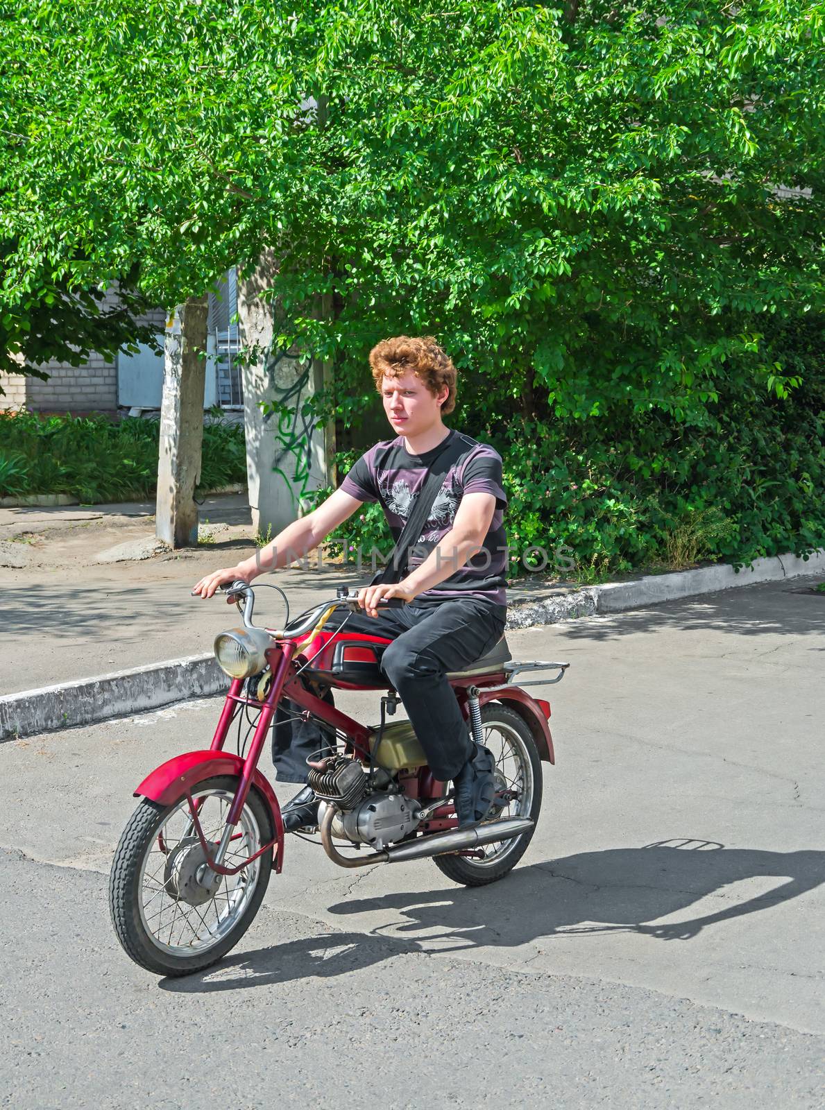 Student rides a moped by myyayko