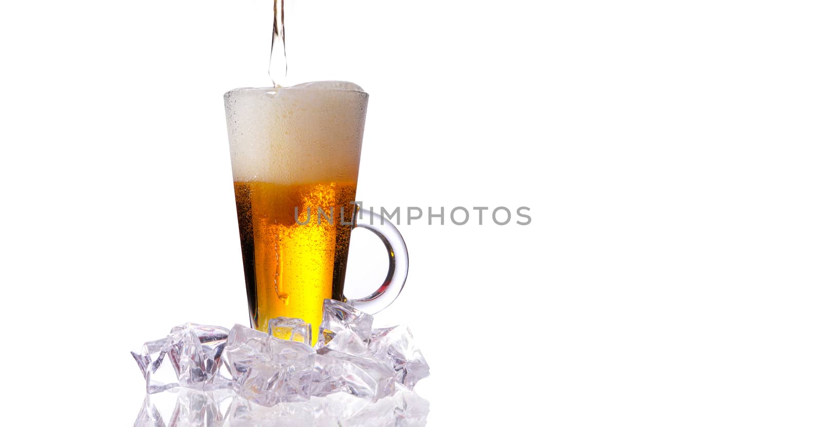 fresh cold beer with ice and foam on white background