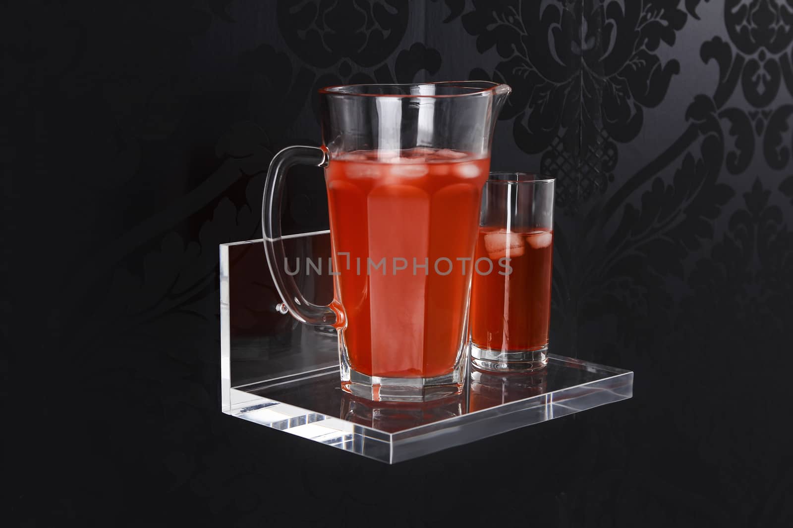 plexiglass display with fluids with red water and black background