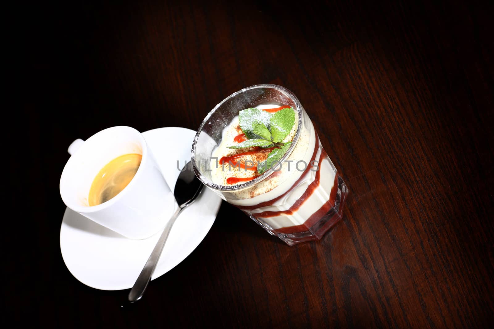 coffee and desert on a table with candle. wood background