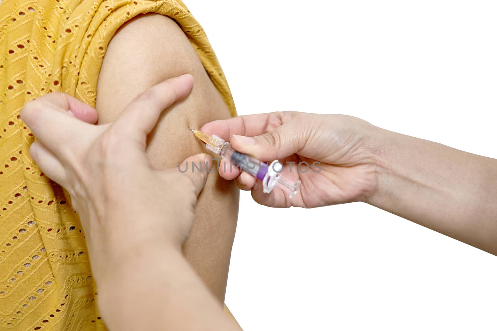 Hand of nurse holding hypodermic syringe injected vaccine of flu with left shoulder of woman in brown blouse isolated on white background. Healthcare and medical concept photography.