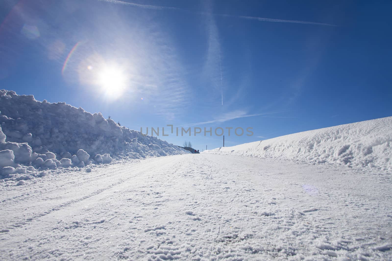 clear blue sky with snow in the mountains of Switzerland, Zugerberg. Track and sun reflection