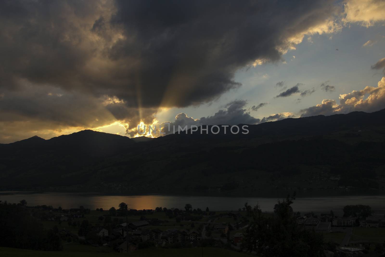 sunset in the mountains. With lake Sarnen, Switzerland with dramatic clouds