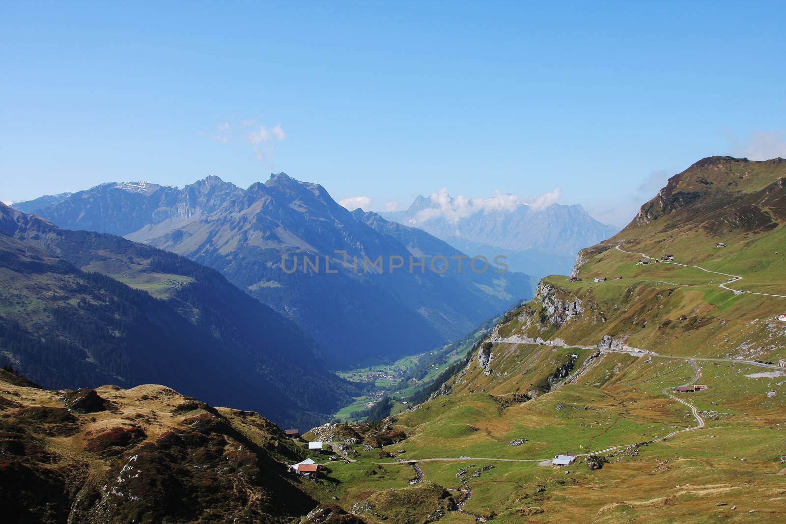 pass road on Klausenpass to canton Uri with mountains and blue sky