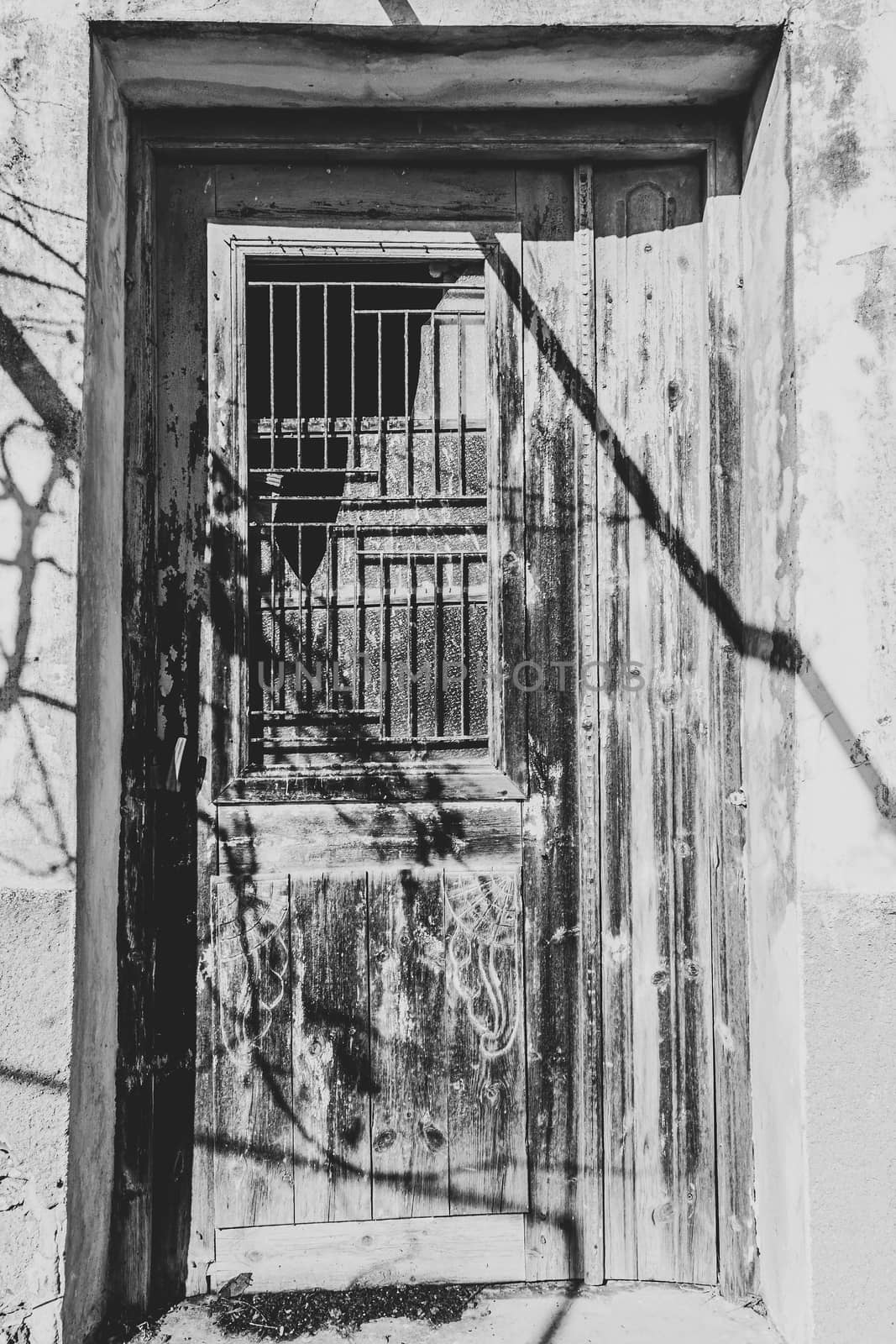 Old wooden door of traditional house in the village Chamaitoulo, Crete, Greece by ankarb