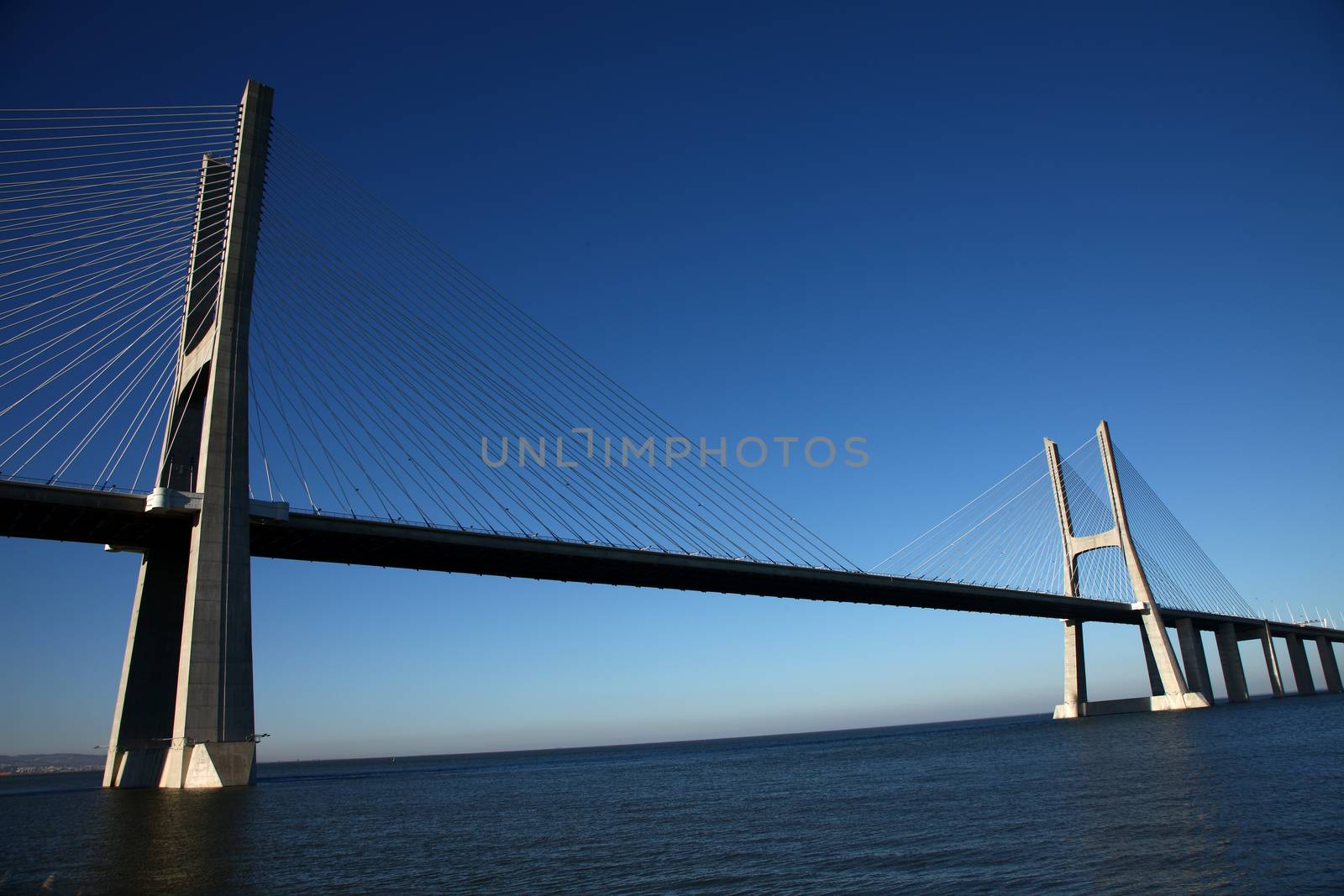 Big bridge over a river in Lisbon, Portugal by PeterHofstetter