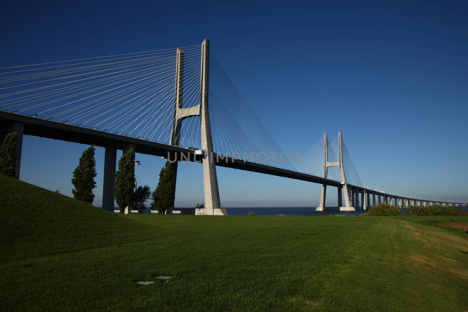 Big bridge over a river in Lisbon, Portugal by PeterHofstetter