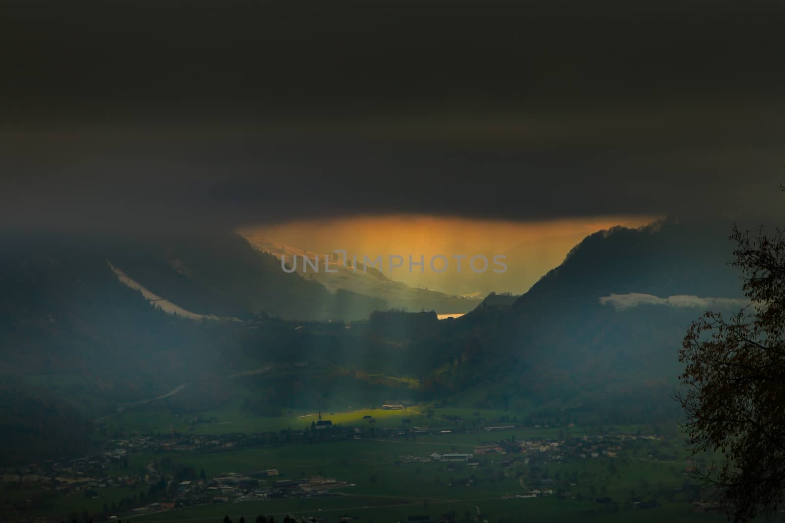 above the fog in Lungern with the swiss Alps, with sun rays over lake