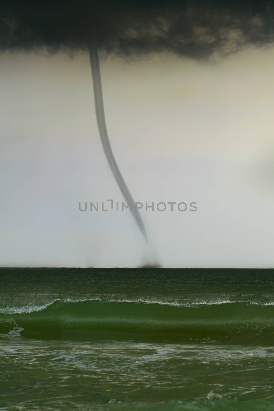 bad weather and storm with the wind on the sea. tornado over the ocean, nature force background - huge tornado, bright lightning in dark stormy sky