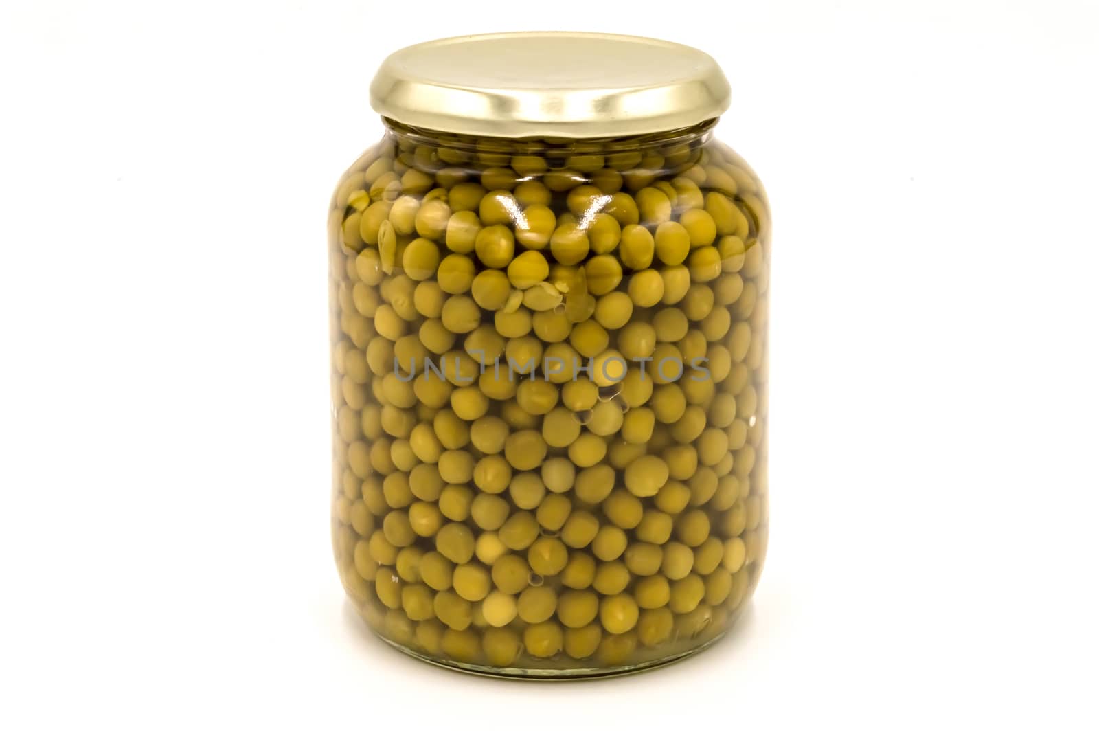 Green peas in a glass jar isolated on a white background