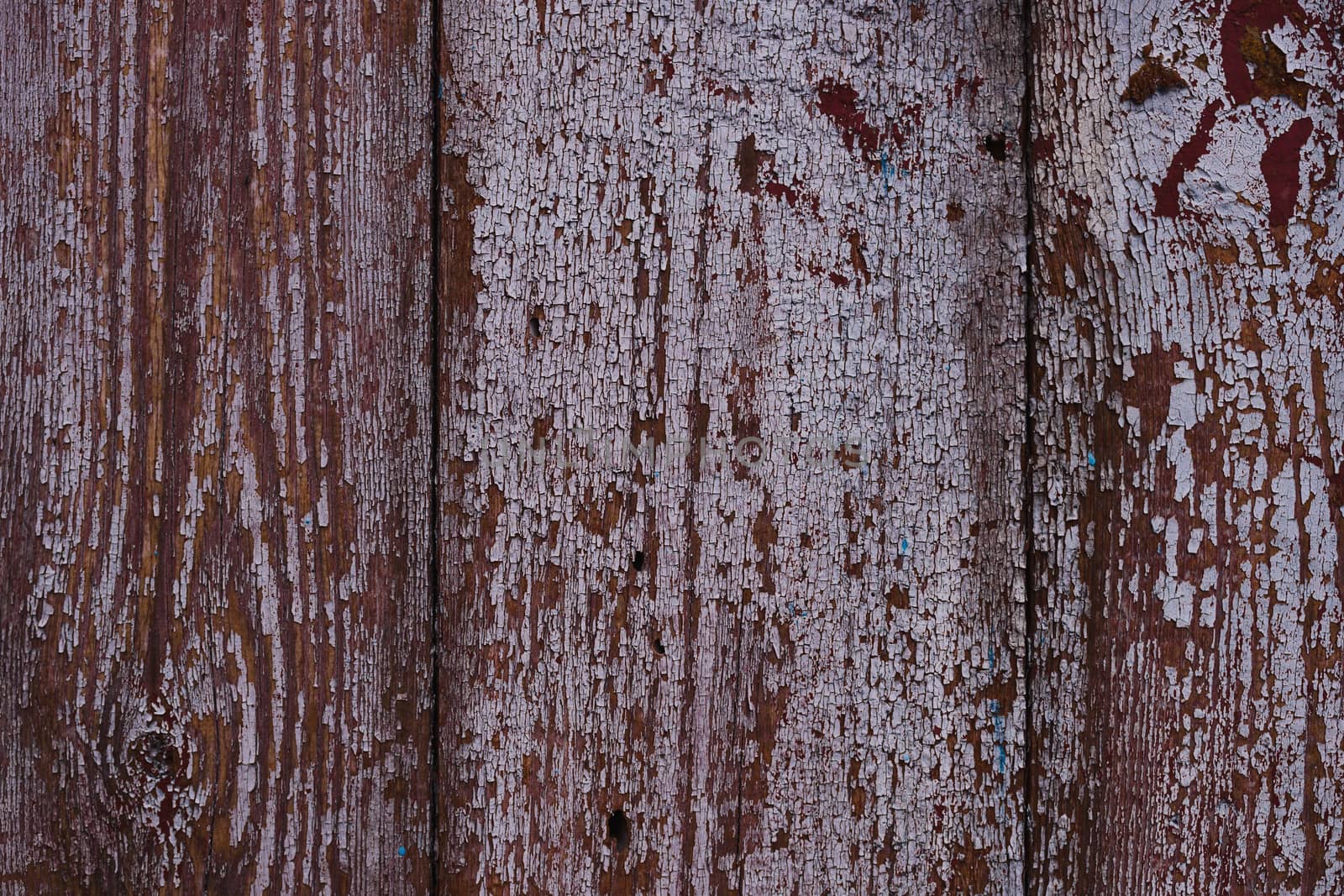 Old red wooden texured door surface closeup. Relief on surface.  by alexsdriver