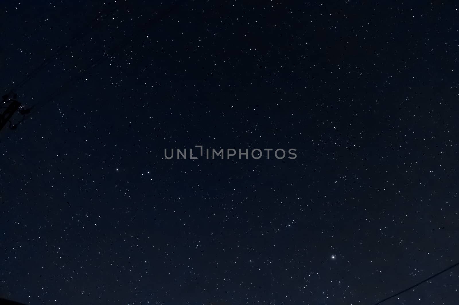 Long exposure night photo of a bright stars. A lot of stars with constellations. Far from the city. Night landscape.