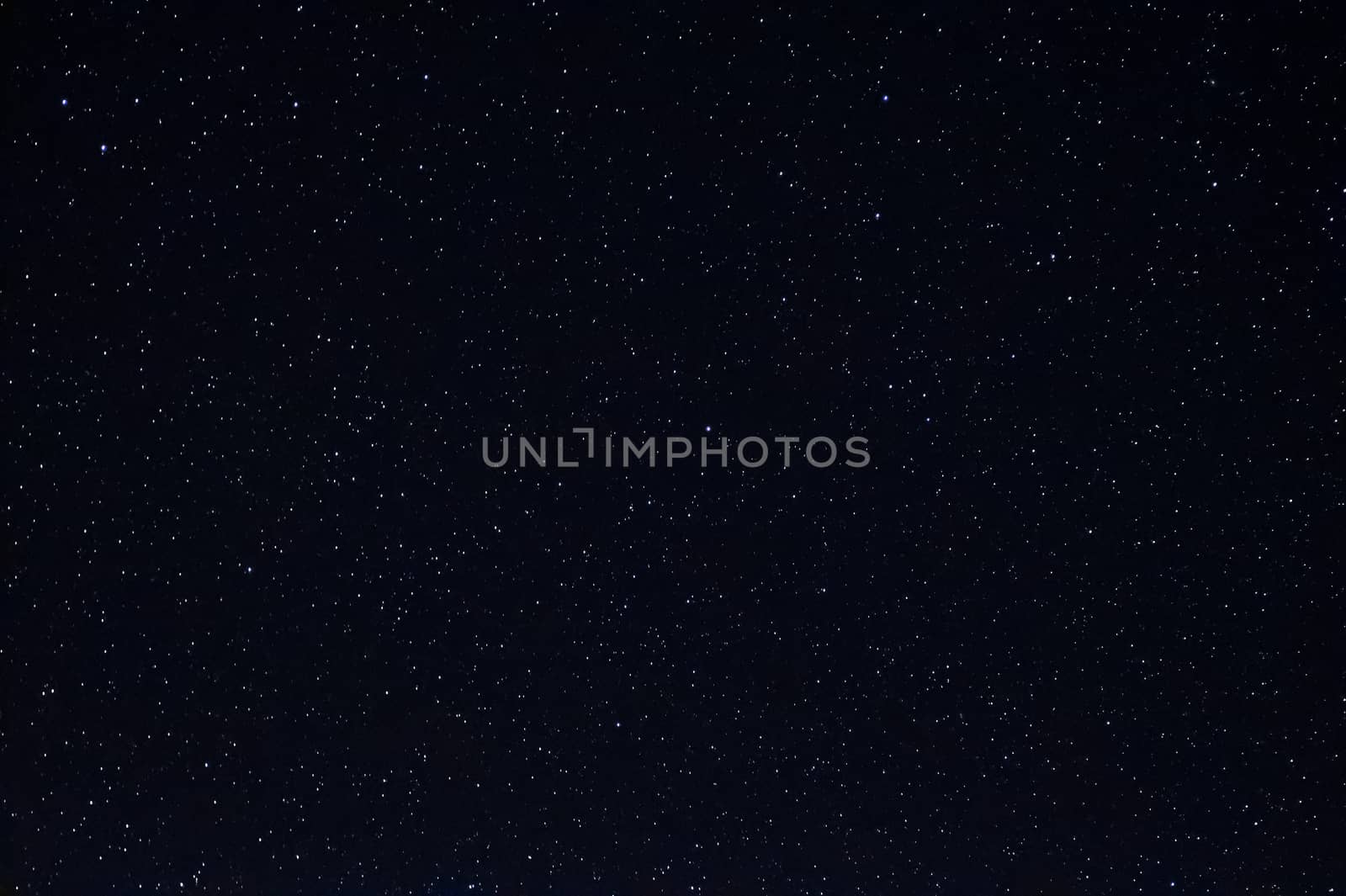 Long exposure night photo of a bright stars. A lot of stars with constellations. Far from the city. Night landscape.