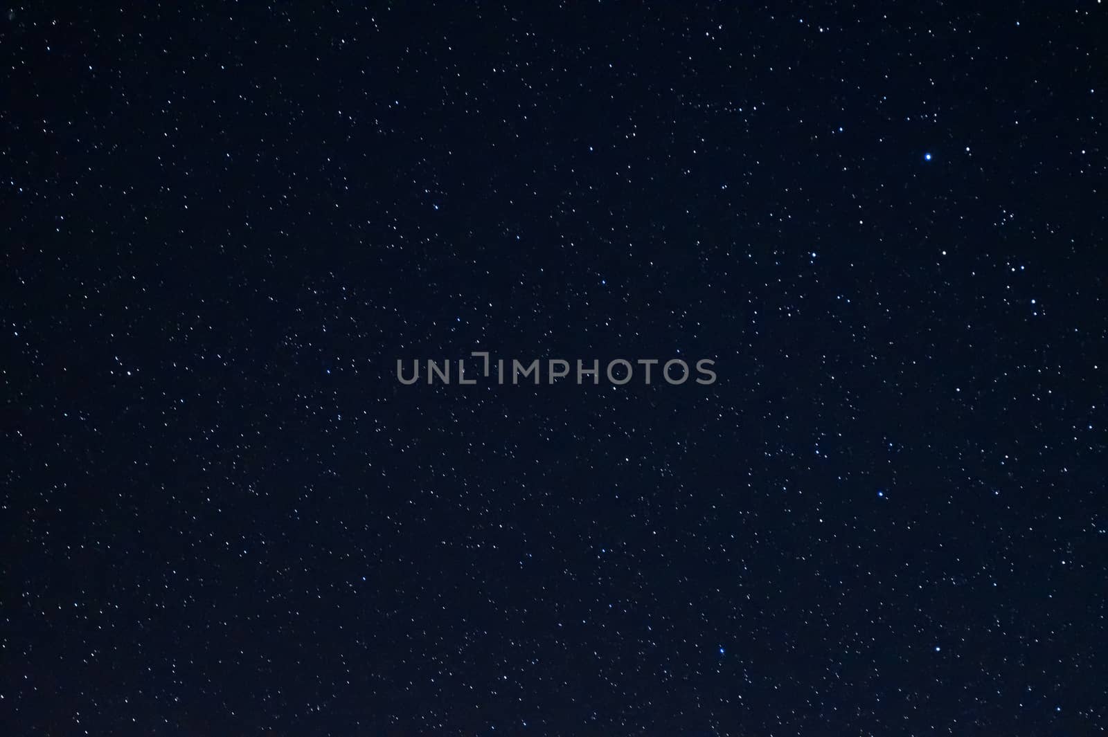 Long exposure night photo of a bright stars. A lot of stars with constellations. Far from the city. Night landscape.