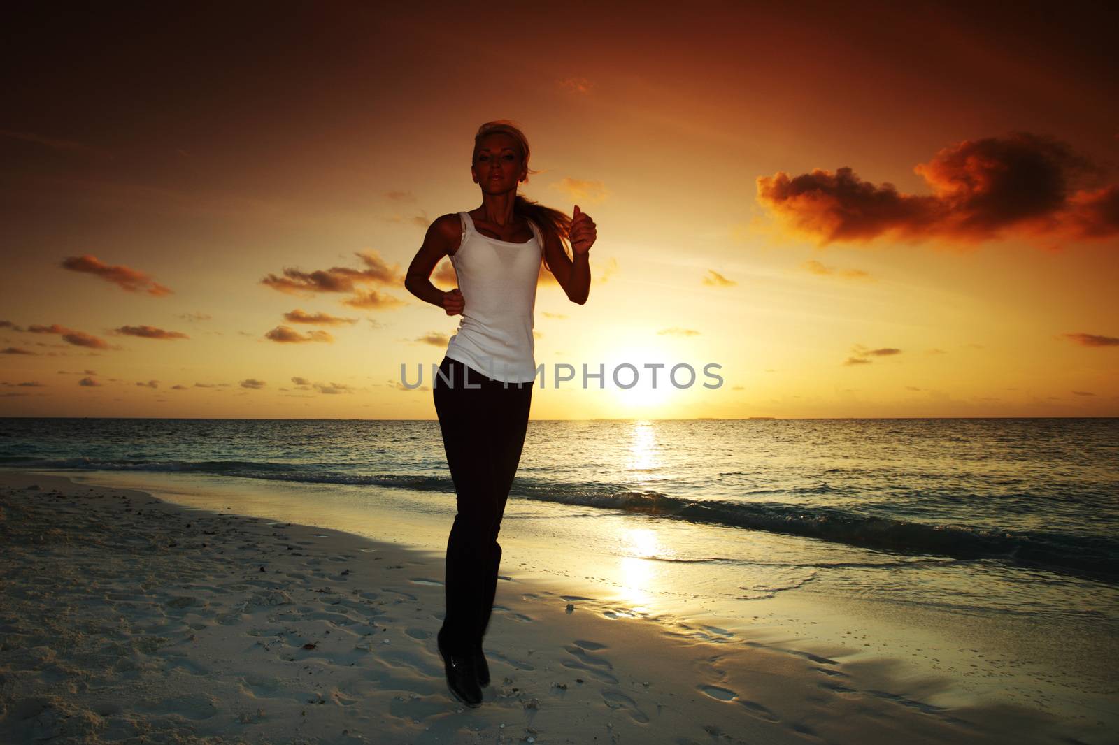 Woman run at sunset by Yellowj