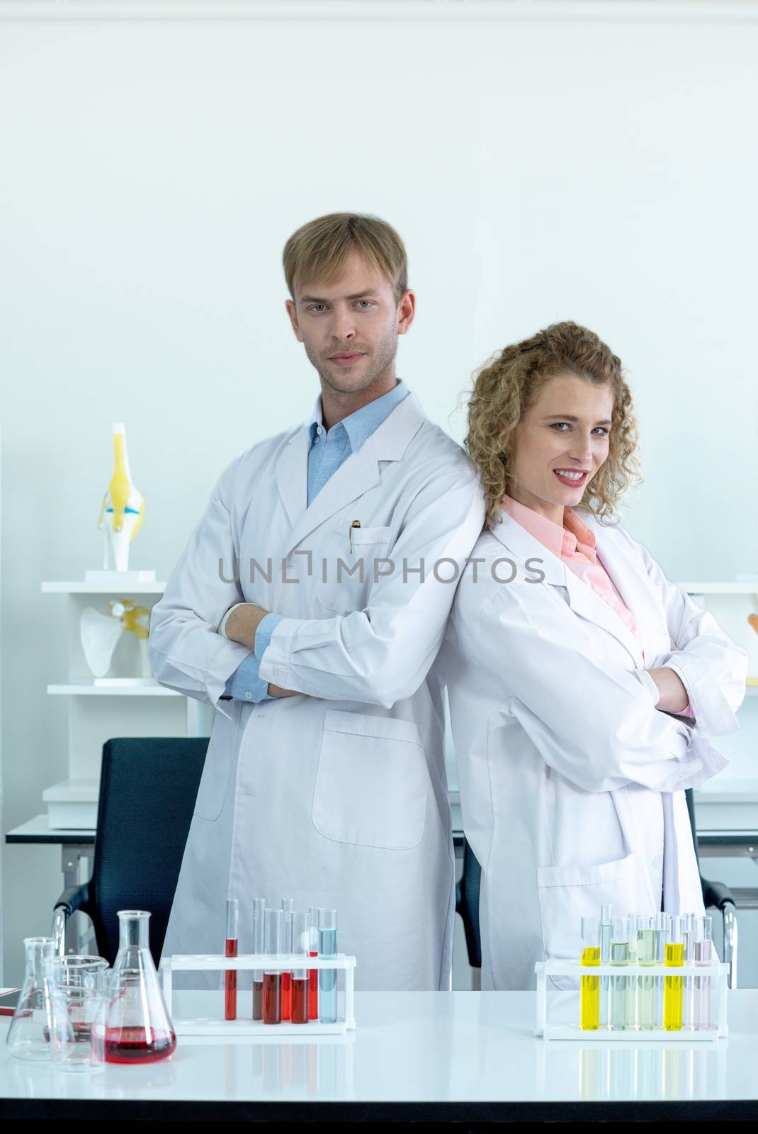 Two scientists stood confidently with folded arms before the experiment began. Working atmosphere in a scientific laboratory.