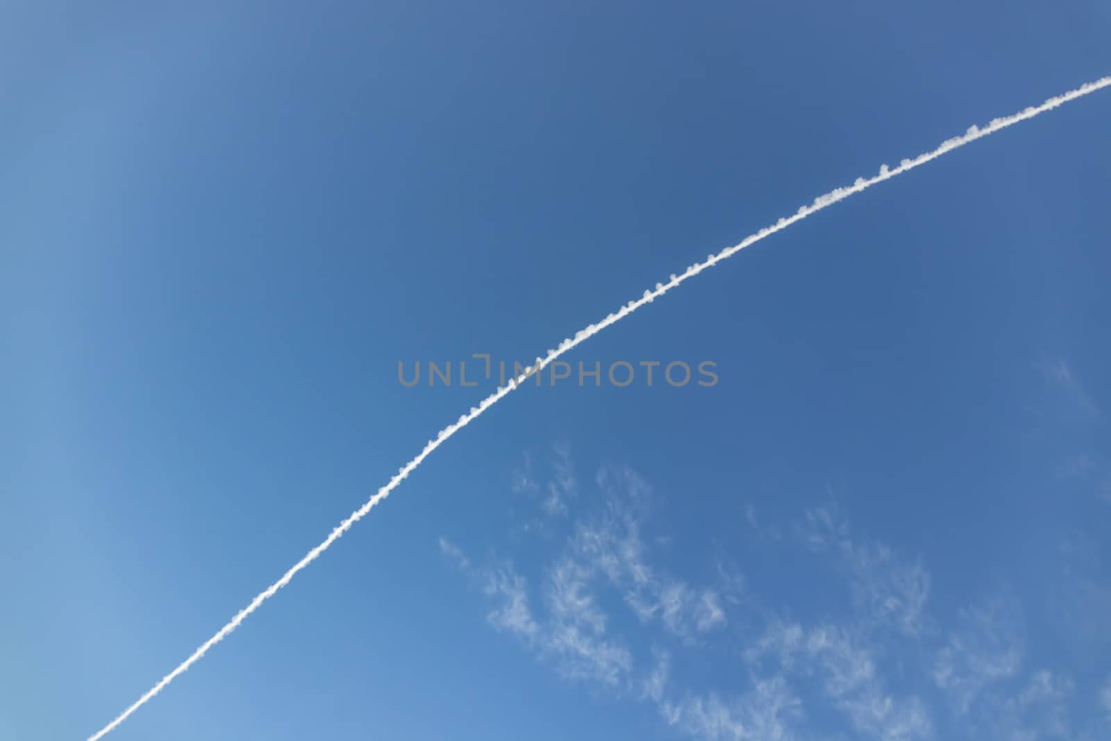 jet fuel trail left by planes at the sky