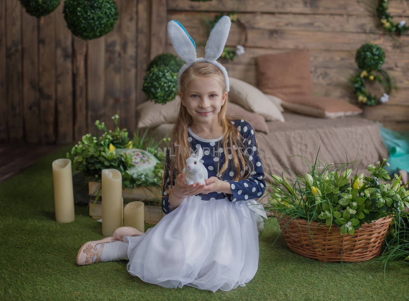 Funny portrait of girl having fun on Easter wearing bunny ears during spring season