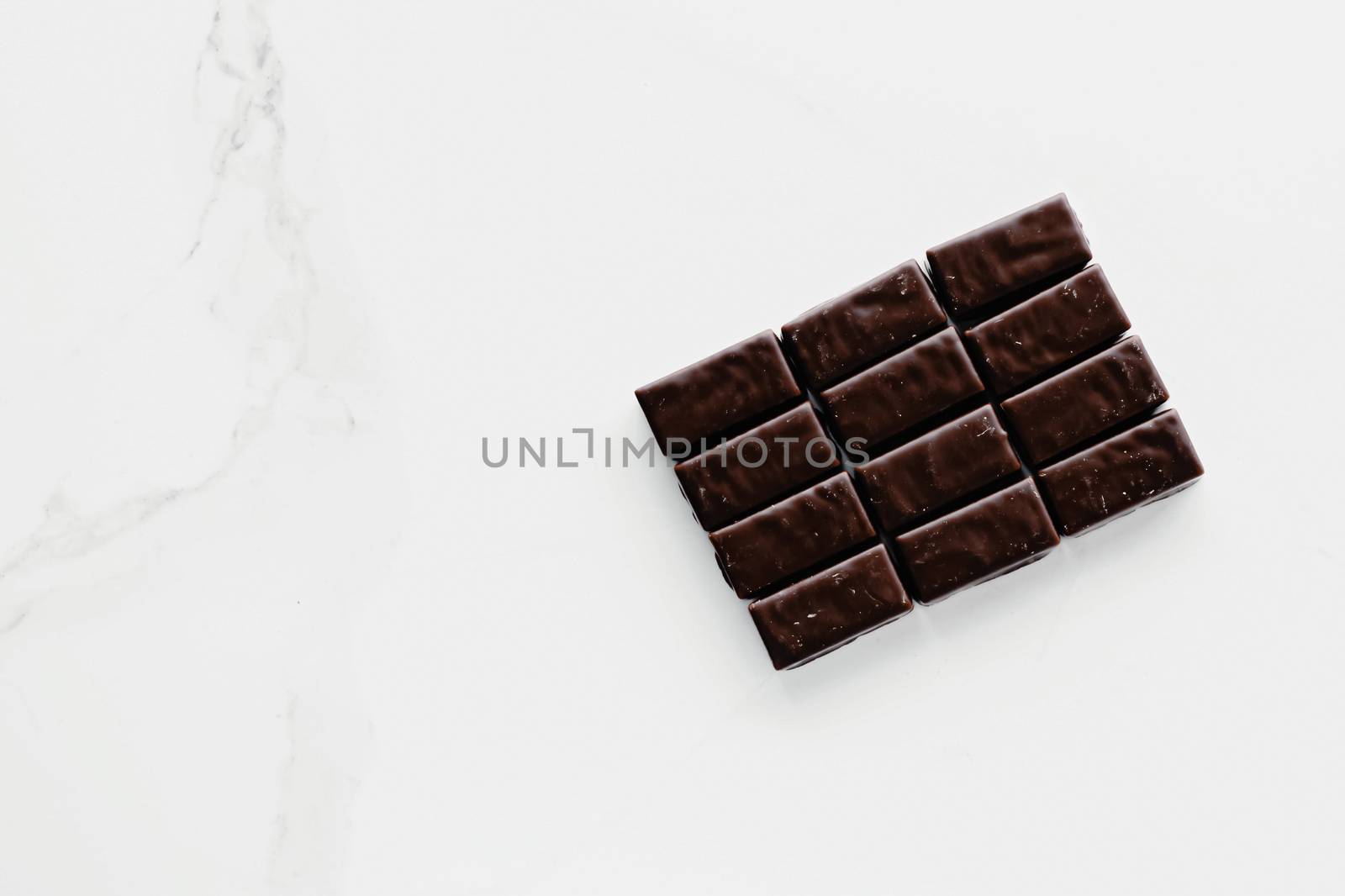Dark chocolate candies isolated on white background, sweet food by Anneleven