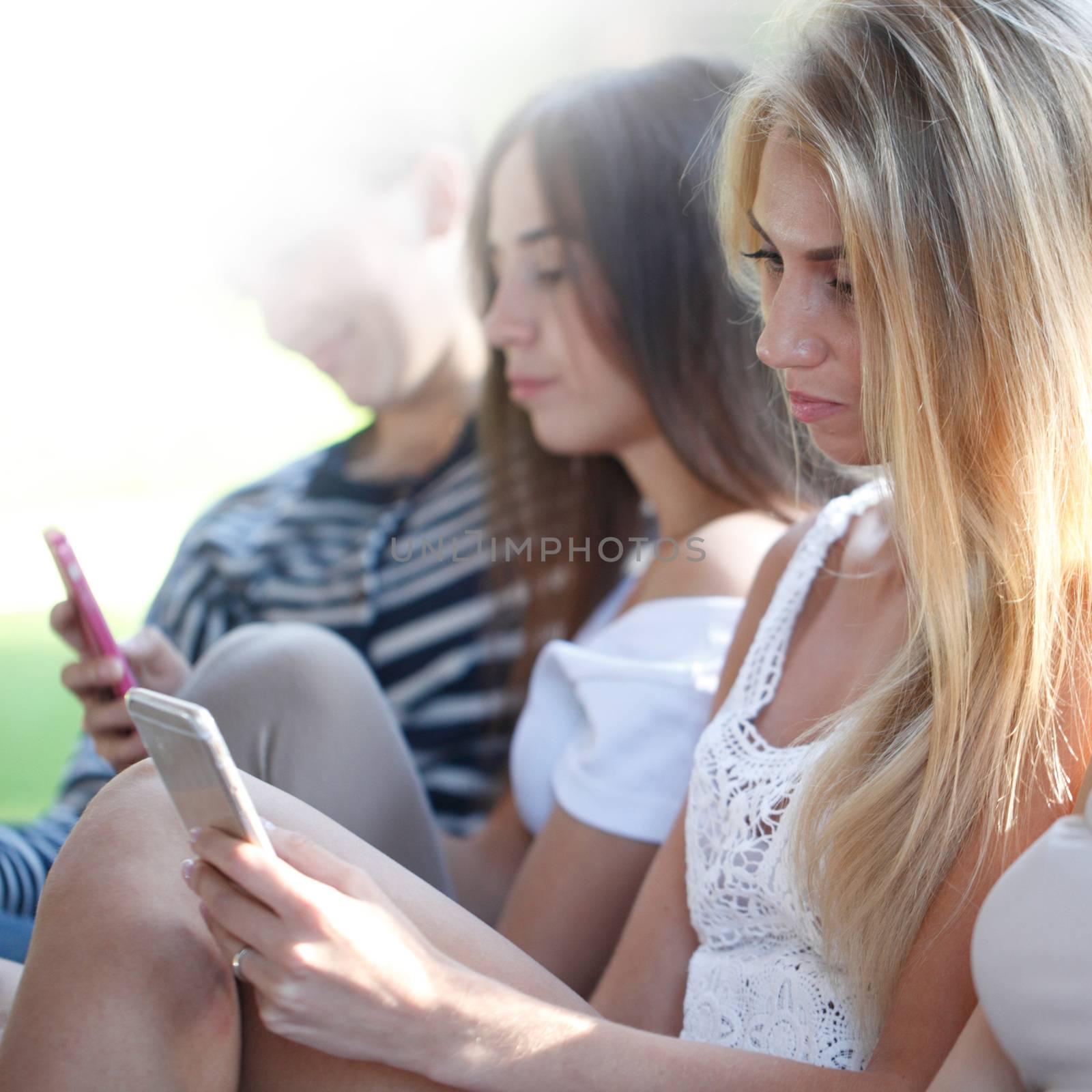 Portrait of young girls chatting with their smartphones outdoors