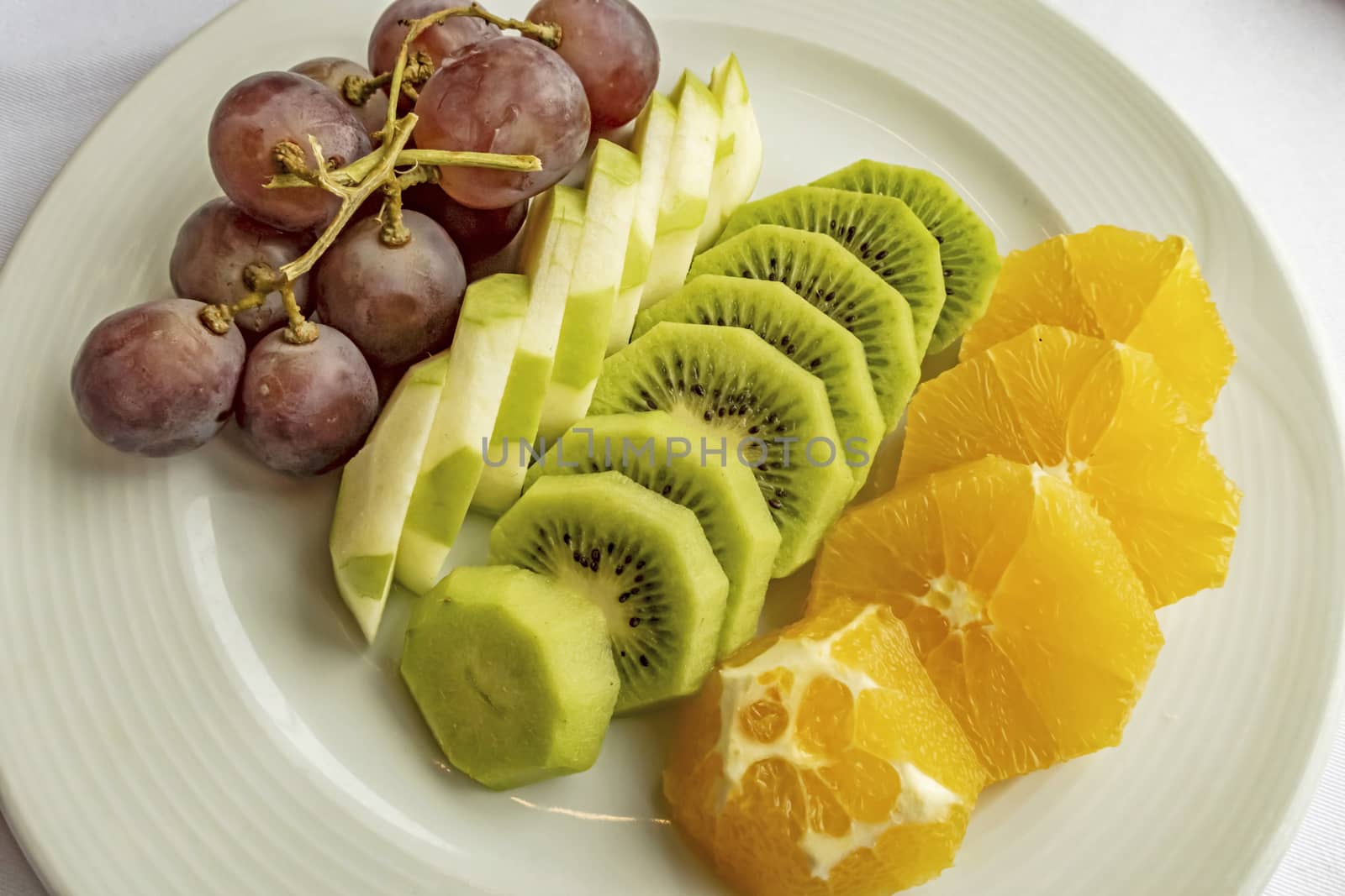 ready to eat sliced mixed fruits in plate