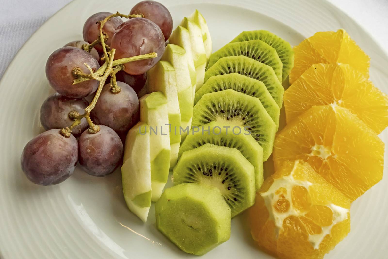 ready to eat sliced mixed fruits in plate