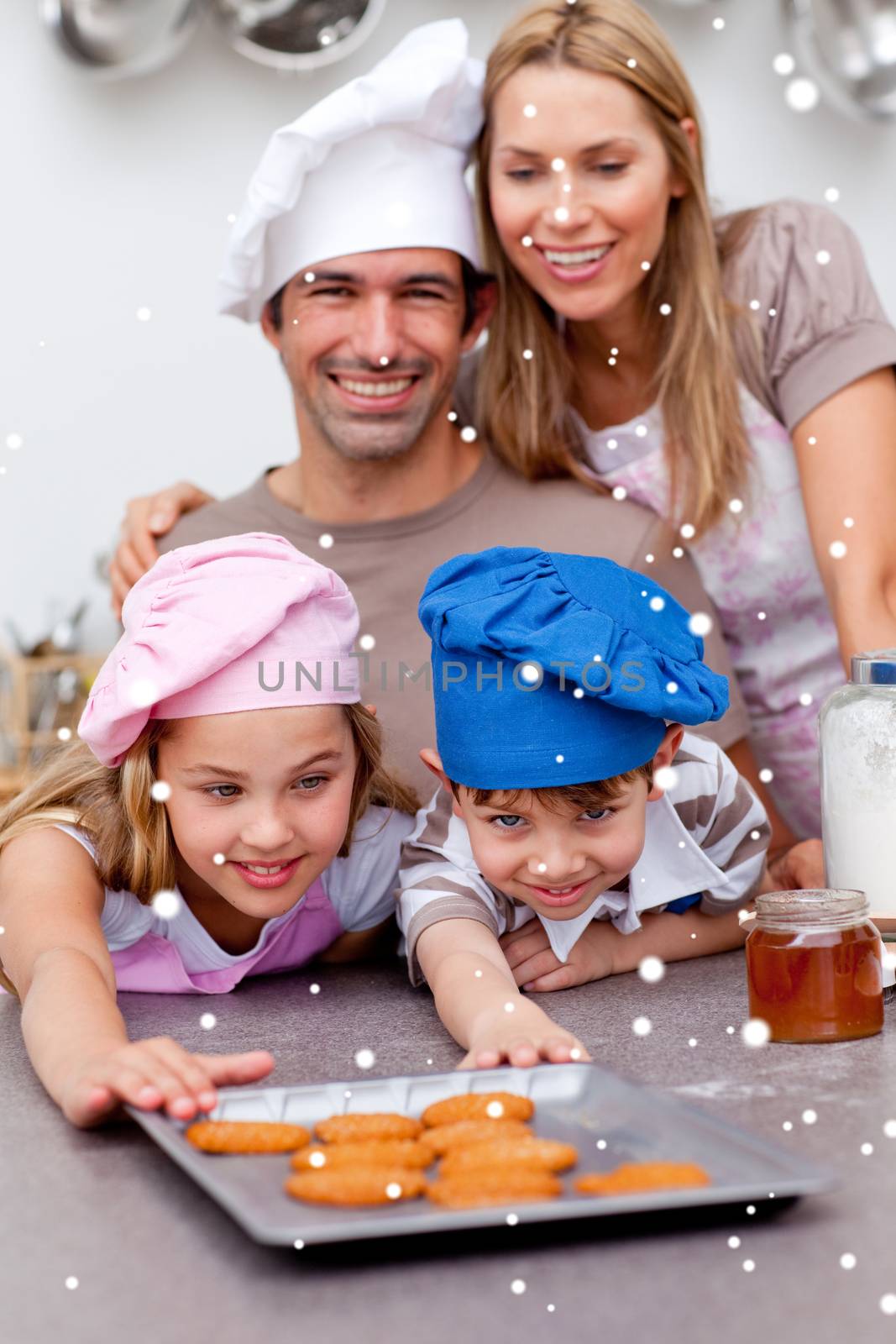 Family eating cookies after baking with snow falling