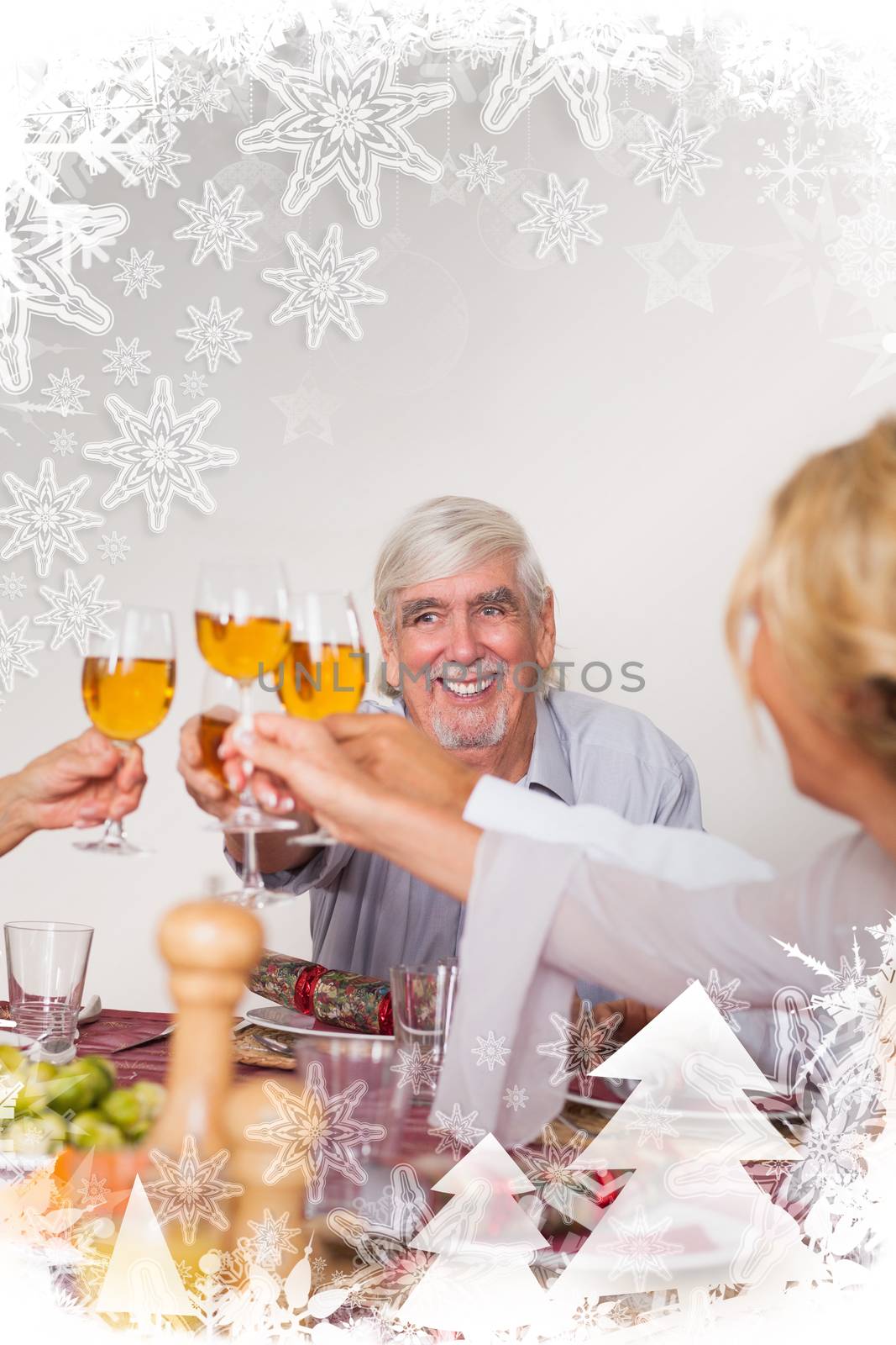Family toasting each other at christmas against christmas frame