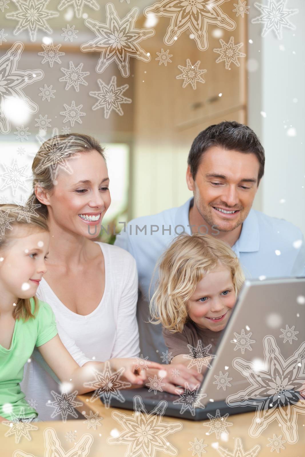 Family using laptop in the kitchen against snowflakes