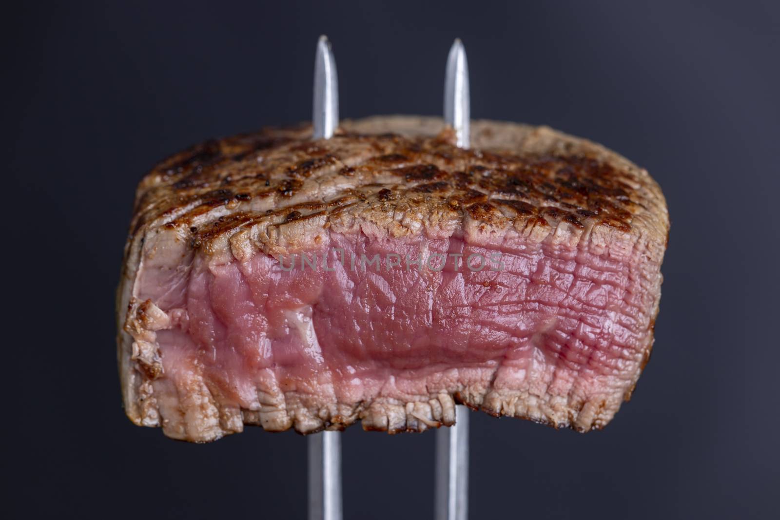 grilled steak on a meat fork