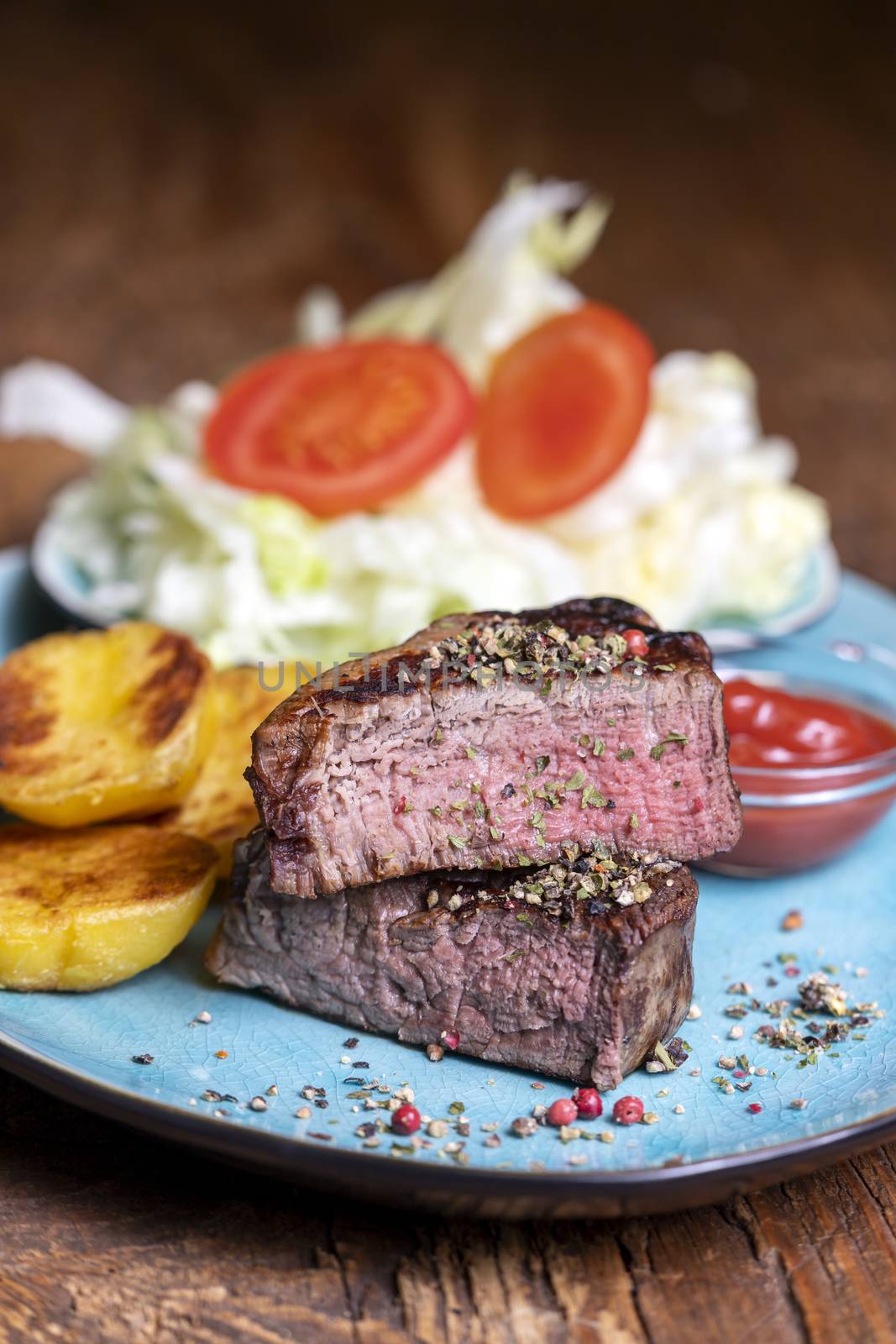grilled steak on a plate by bernjuer